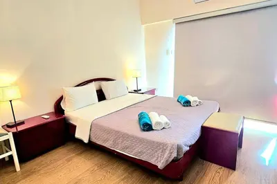 a hotel room with a bed with towels on it at Dasoudi Pecora Beach Apartment in Limassol