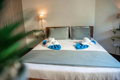a bed with two stuffed animals on top of it at Bluewave Apartment in Pyla