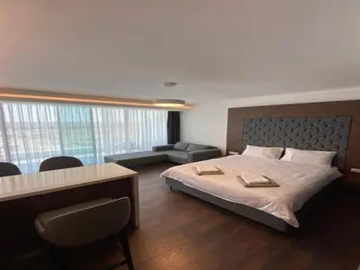 a bedroom with a bed and a desk and a couch at Grand Sapphire,Luxury Residence BY Report Homes Northern Cyprus in Ayia Napa