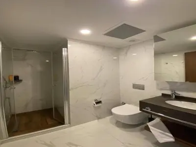 a bathroom with a shower and a toilet and a sink at Grand Sapphire,Luxury Residence BY Report Homes Northern Cyprus in Ayia Napa