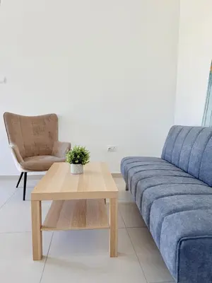 a living room with a blue couch and a coffee table at Kiti Traditional Residences in Larnaka