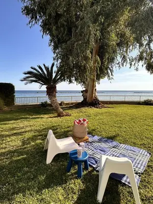 a picnic with a cake on a table and two chairs at Melon Boutique Seafront Apartment in Limassol