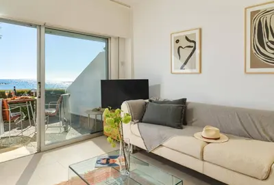 a living room with a couch and a glass table at Melon Boutique Seafront Apartment in Limassol