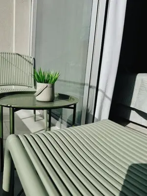 a small balcony with a table and a chair at Grace Living in Limassol