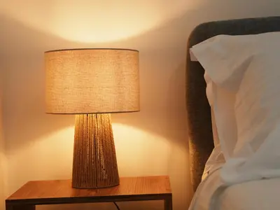 a lamp on a table next to a bed at Grace Living in Limassol