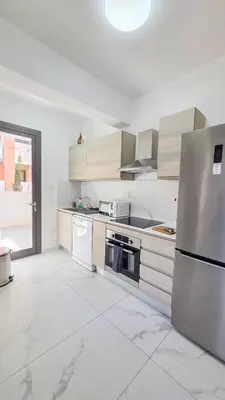 a kitchen with a stainless steel refrigerator and appliances at Pool Citylux Apartment in Larnaka