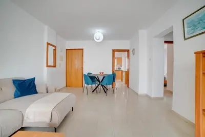 a living room with a couch and a table at Cozy Mackenzie Getaway in Larnaka