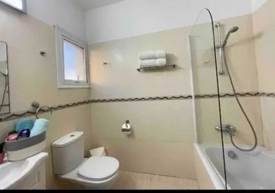 a bathroom with a toilet and a glass shower at Villa Flamingo ,private pool & Sea view in Ayia Napa