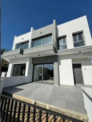 a large white house with a fence in front of it at Villa - Sleeps 6 - Near Local Attractions in Limassol