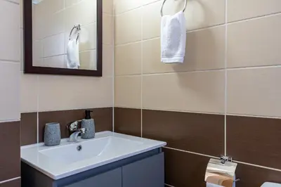 a bathroom with a sink and a mirror at Ondo 2-Bedroom Apartment in Larnaka