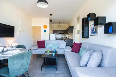 a living room with a couch and a table at Ondo 2-Bedroom Apartment in Larnaka