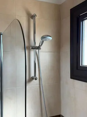a shower with a shower head in a bathroom at NEW - Agia Marina - Rural Retreat with Shared Pool & Parking in Avgorou