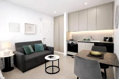 a living room with a couch and a table at White Arches Studio Suite by TrulyCyprus in Limassol