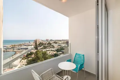 a room with a large window with a view of the beach at Limanaki Beach Aparment in Larnaka