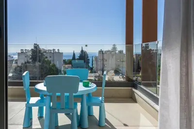a table and chairs on a balcony with a view at Pearl Beach Luxury Family Suite in Limassol