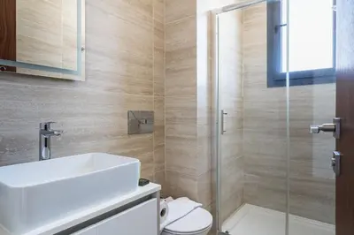 a bathroom with a toilet and a sink and a shower at Pearl Beach Luxury Family Suite in Limassol
