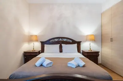a bedroom with a bed with two blue pillows at Beachfront Luxury Living Limassol in Limassol