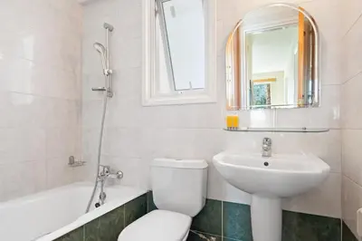 a bathroom with a toilet and a sink and a bath tub at Spacious City Centre Living in Nicosia
