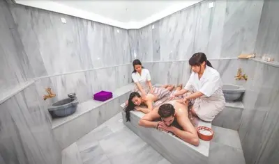 a group of people sitting on a toilet in a bathroom at THE PALMiA I iskele I Trikomo in Aglantzia
