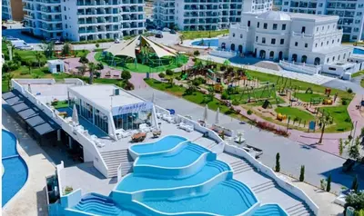 a resort with a swimming pool and a water park at THE PALMiA I iskele I Trikomo in Aglantzia