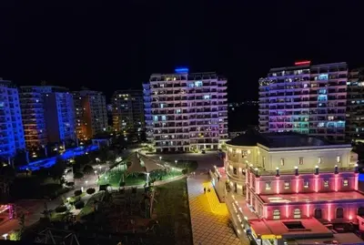 a view of a city at night with buildings at THE PALMiA I iskele I Trikomo in Aglantzia