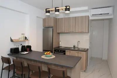 a kitchen with a island with a bowl of fruit on it at ELIA Elegant Central Suite Larnaca in Larnaka