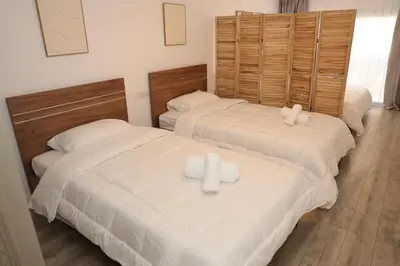 two beds sitting next to each other in a bedroom at ELIA Elegant Central Suite Larnaca in Larnaka