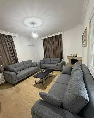 a living room with two couches and a table at Villa Keskin - Girne in Ayios Ioannis