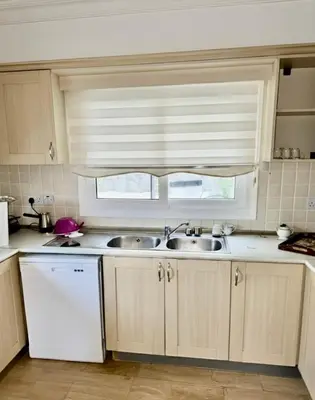 a kitchen with a sink and a window at Villa Keskin - Girne in Ayios Ioannis