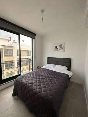 a bedroom with a bed and a large window at Moonlight Home in Nicosia