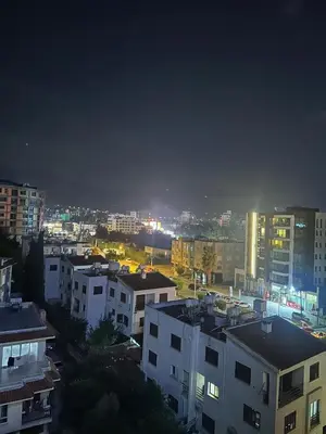 a view of a city at night with buildings at Moonlight Home in Nicosia