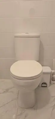 a white toilet in a bathroom with a white wall at Habito Luxury Apartment - Breakbooking CY in Limassol
