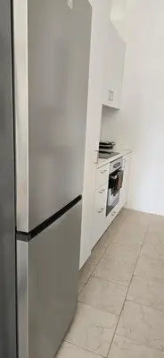a kitchen with a stainless steel refrigerator and a stove at Habito Luxury Apartment - Breakbooking CY in Limassol
