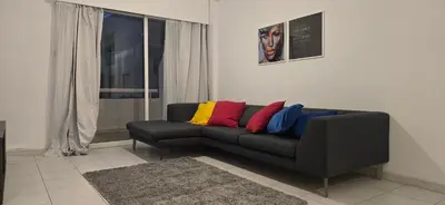 a living room with a black couch with colorful pillows at Executive 2BR Spacious Apartment , Limassol Center, 2 Balconies, Ideal Business Stay - SuperCentro! in Limassol