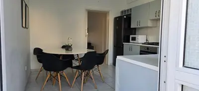 a small kitchen with a small table and black chairs at Executive 2BR Spacious Apartment , Limassol Center, 2 Balconies, Ideal Business Stay - SuperCentro! in Limassol