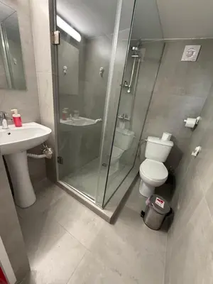 a bathroom with a shower and a toilet and a sink at RED Cabin-Larnaca Centrum in Larnaka