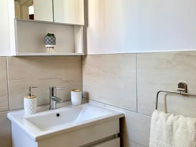 a bathroom with a white sink and a mirror at Charming 1-BR Stay Near City Centre, Marina and Beaches - Perfect for Couples, Business or Solo Travellers in Limassol