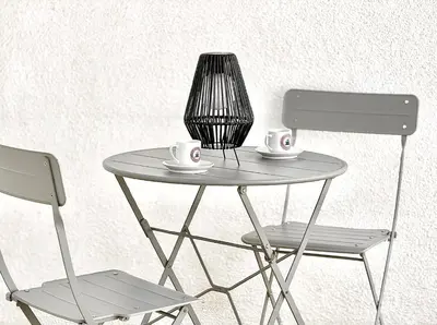 a table with two chairs and two cups on it at Charming 1-BR Stay Near City Centre, Marina and Beaches - Perfect for Couples, Business or Solo Travellers in Limassol