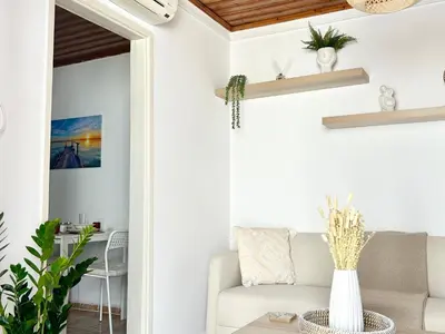 a living room with a couch and a table at Charming 1-BR Stay Near City Centre, Marina and Beaches - Perfect for Couples, Business or Solo Travellers in Limassol