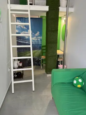 a room with a bunk bed and a green couch at GREEN Cabin-Larnaca Centrum in Larnaka