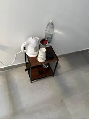 a table with a tea kettle and a water bottle on it at BLUE Cabin-Larnaca Centrum in Larnaka