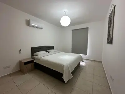 a bedroom with a bed in a white room at 2 Bedroom Penthouse Apartment With Swimming Pool in Kiti