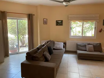a living room with a couch and a window at Holiday House in Oroklini in Voroklini