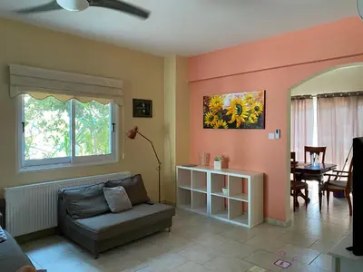 a living room with a couch and a table at Holiday House in Oroklini in Voroklini