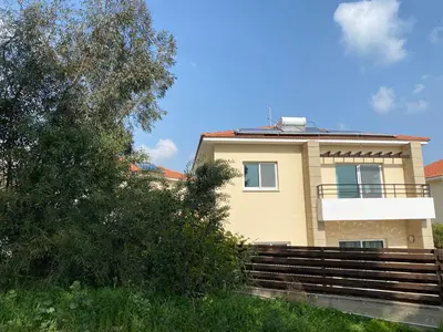 a yellow house with stairs in front of it at Holiday House in Oroklini in Voroklini