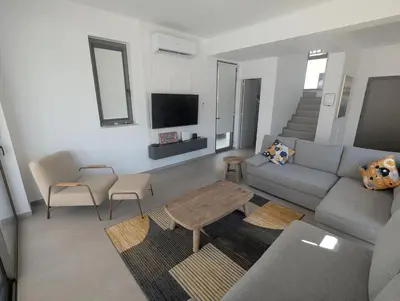 a living room with a couch and a table at Ruach Villa in Paralimni