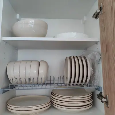 a closet with plates and bowls on a shelf at Ruach Villa in Paralimni
