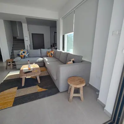a living room with a couch and a table at Ruach Villa in Paralimni