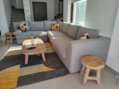 a living room with a couch and a table at Ruach Villa in Paralimni