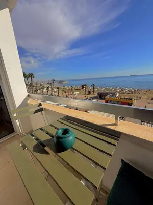 a green ball sitting on a bench on a balcony at Golden Nest by the Sea in Larnaka